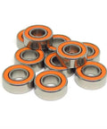 Top Tier 140 Piece Hybrid Ceramic Bearing Assortment With Stainless Steel Balls, orange-sealed bearings stacked for high-speed runs.
