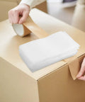 Person taping a box with Pro Grade EPE Foam Pouches With High Shock Absorption And Lightweight Cushioning 200 Count White for packing