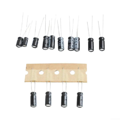 Top Shelf Motherboard Repair Kit With Assorted Capacitors, 25 black metal capacitors mounted on a paper strip for easy use.
