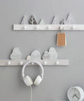 Solid Wooden Wall Mounted Coat Rack With Key Holder Smooth Black Finish Multi Purpose Entryway Organizer For Coats Hats Towels No Sweat Setup Straight Up Top Shelf Storage with decorative mountain and tree designs.