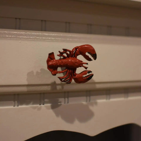 Premium Red Lobster Metal Drawer Pulls Featuring A Slick Distressed Finish For Nautical Cabinet Hardware, mounted on a white drawer.