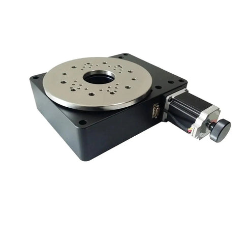Slick High Precision Motorized Rotary Positioning Stage Delivering Buttery 360 Degree Rotation With Tight Worm Gear Mechanics And A Solid 100 Millimeter Indexing Base For Dead Center Performance viewed from an angle, showing metal surface and motor.