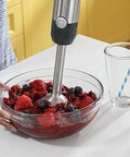 No Sweat 500 Watt Stainless Steel Immersion Blender With Removable Whisk And Spout Blending Jar blending fruit in bowl.