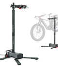 Electric Height Adjustable Bike Repair Stand With 100 Lb Capacity Hands Free Foot Lift Fast Ratchet Clamp shown upright with ebike.