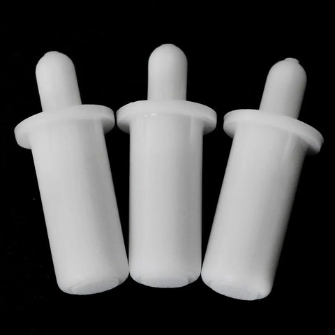 Close-up view of three white plastic spring loaded shutter louver replacement pins from the Twenty Piece Collection Of Spring Loaded Shutter Louver Replacement Pins Providing A No Sweat Upgrade For Fast Air Vent Repairs Using Heavy Duty Matte White Plastic Components.