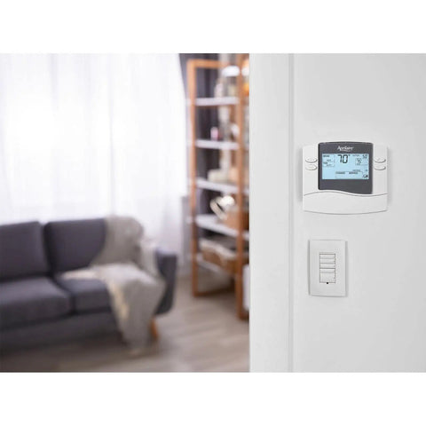 Non Programmable Thermostat With Backlit Display For Easy Readout Of Room Temperature And Outdoor Temperature on wall