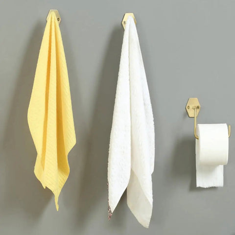 Top Shelf Brass Wall Hooks For Towels And Mugs No Sweat Rust Proof Bathroom Hanger holding yellow and white towels on a gray wall.