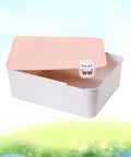 Open pink plastic underwear storage box with marked lid for under bed closet drawer organization.