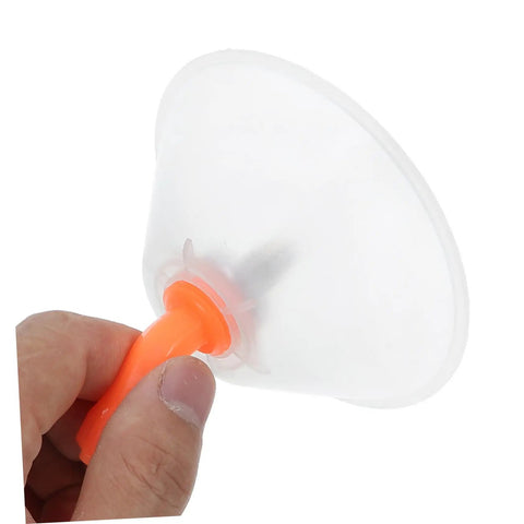 Hand holding a translucent cone cover from Windproof Sprayer Nozzles Drift Guard Two Pack For Garden Use Sprayer Tanks