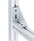 Close-up of a 90-degree aluminum corner bracket attached to a 4040 t slot frame with pre-drilled M8 holes.