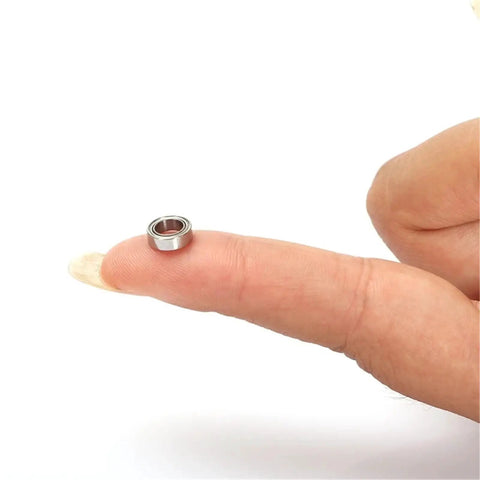 Premium Stainless Steel Deep Groove Ball Bearings Miniature Smr63zz on a fingertip showcasing size and design.