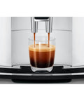 Straight Up Game Changer Automatic Espresso Coffee Maker With Easy Cappuccino Function And Premium Aroma Grinder In Sleek Piano White Finish pouring espresso into a glass.