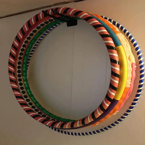 Heavyweight Garage Storage Hooks Built Like Tanks Featuring Scratch Resistant Rubber Sleeves For Rust Free Workshop Wall Tool Organization And Shop Rig Setup, displaying colorful hula hoops mounted.
