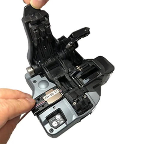 High Performance Japanese Import CT-50 Optical Fiber Cleaver with precise mechanism and operator handling fiber cable.