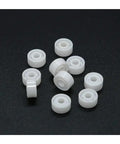 Top Shelf Zirconia Ceramic Ball Bearings Built Solid For Demanding Workshops, ten white ceramic balls on a black background.