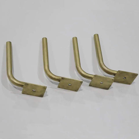 Step Up Your Space Game With Beefy Stainless Steel L Shaped Table Legs, Gold Brushed Heavy Duty Sofa Risers, Rust Resistant Lift Foot Accessories, Tough Support For Tv Stand, Pack Of 4. Four gold brushed steel table legs with square bases.