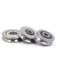 10 Pack Miniature Ball Bearings V Groove And U Groove Wire Guide Track Rollers in steel, 3 rollers with smooth surfaces.