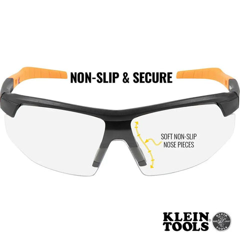 Top Tier Semi Frame Safety Glasses With Clear Lens Pack Serious Eye Protection And Scratch Resistant Coating Built Tough For The Daily Grind While Giving Comfy Wrap Around Coverage That Keeps Your Vision Sharp On Site. Close-up of safety glasses showing non-slip nose pieces and orange side grips.