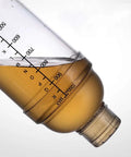 Close-up of the Clear Plastic Cocktail Shaker With Measurement Scale 33 Oz Handheld Drink Mixer showing scale and liquid content