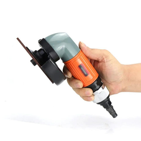 Badass 4 Inch Pneumatic Angle Grinder For Heavy Duty Polishing And Grinding Featuring Front Exhaust Cooling Adjustable Speed Switch And Rugged Metal Spark Guard Cover held in hand, showcasing compact design and angled head.