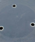 Close-up of five inch adhesive back sanding pad for random orbit sander attachments with three vent holes.