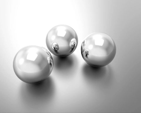 Get Top Shelf Performance With These Bad Ass High Precision G Twenty Five Grade Chrome Steel Ball Bearings Measuring One Point Five Inch In Diameter Hot Forged For Ultimate Durability And Reliability Perfect For Heavy Duty Applications - chrome steel ball bearings on reflective surface.