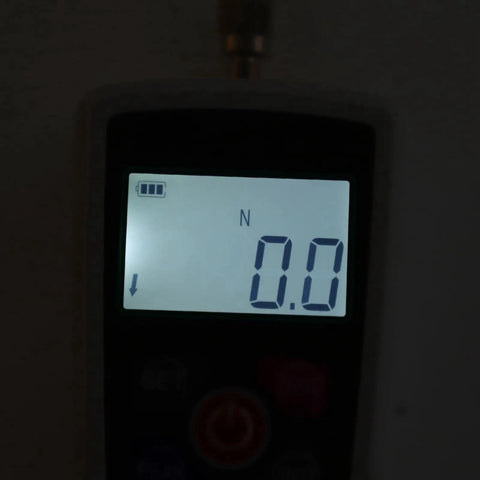 Close-up of Hella Accurate Mini Digital Force Gauge Featuring 50 Up To 500N Measurement Range Built In Sensor, displaying 0.0 N.
