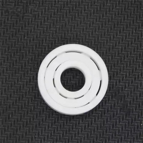 Full Ceramic Bearing ABEC-9 Precision ZrO2 Zirconia Deep Groove Ball Bearing 5x10x4 Millimeters on textured black background.