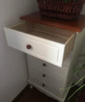 Ten Pack Round Wood Drawer Knobs Warm Red Brown Finish installed on white dresser with partially open drawer.