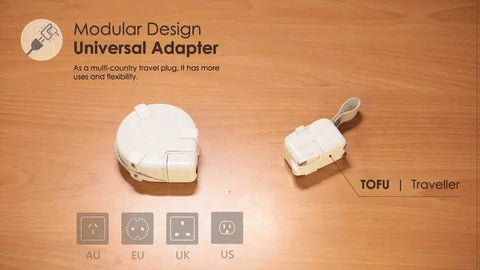 Power Station Traveler Bundle With Universal Travel Adapter on wooden table, featuring modular design and multiple plug types.