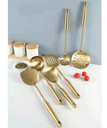 Gold Stainless Steel Kitchen Utensil Set With Spatula, Slotted Spoon, Ladle, Turner And More displayed on kitchen counter