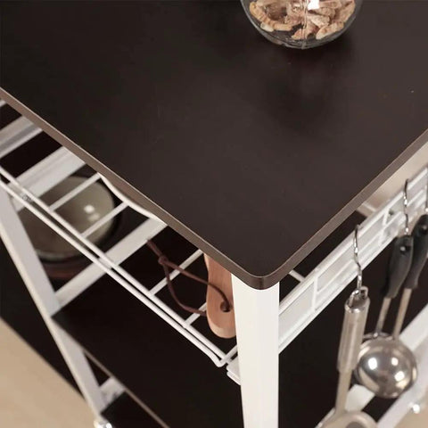 Heavy Duty Three Tier Kitchen Storage Rack And Slick Baking Station With Powder Coated Metal Frame and Sturdy Laminate Shelves top view showcasing black laminate surface and kitchen tools.