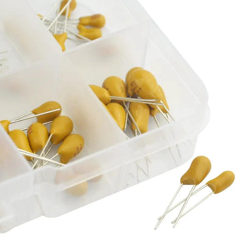 Rock Solid Tantalum Capacitor Assortment Kit Featuring One Hundred Pieces Across Ten Distinct Values Ranging From One To One Hundred Microfarads At Sixteen Volts Inside A Nifty Storage Box with yellow capacitors in a transparent storage container.