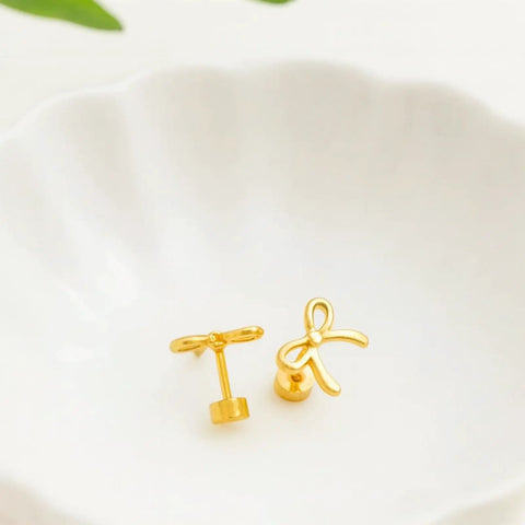 Gold Bow Stud Earrings For Women Titanium Flat Back Screw Back Hypoallergenic Nickel Free Lightweight on a white dish.