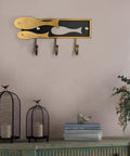 Super Sturdy Goldfish Shaped Wall Mount Coat Hook For Clothes Hats Towels Easy Peasy Install, displayed on a wall with decorative items.