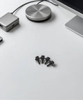 Fifty Pack M5 X25 Metal Cage Nuts And Rack Screws Rock Solid Heavy Duty Gear For Server Rigs And Network Cabinets arranged on a desk.