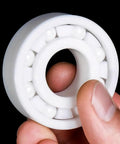 Top Tier Zirconia Full Ceramic Ball Bearings Run Ultra Fast And Stay Cool Under Load, 80x140x26mm, held in hand.