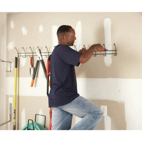 Man using Cordless Screwdriver With Forward And Reverse Switch, Manual Screw Driving Option, Built In Peg Hole, AA Battery Powered
