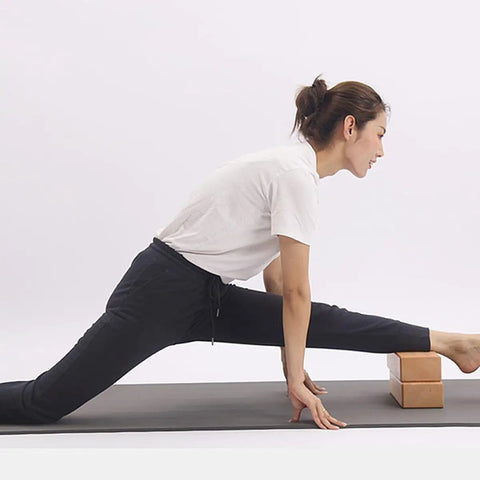 Premium Natural Solid Wood Yoga Block With Rounded Corners And Slick Grip For Legit Balance Training And Killer Flex Stretches And Top Shelf Core Conditioning Sessions used for stretching leg.
