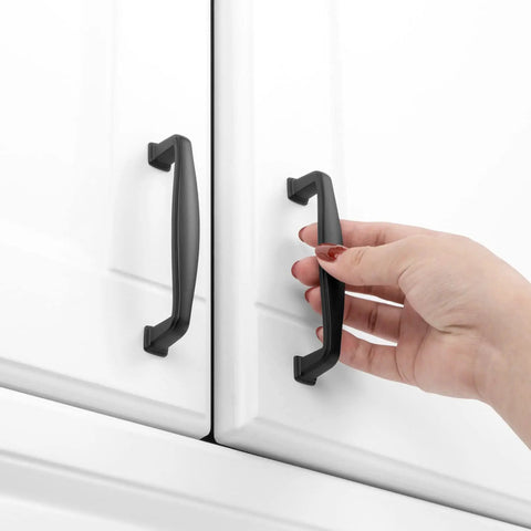 Grab These Sick Matte Black Cabinet Pulls Perfect For Any Renovation Vibe 10 Pack Of Rock Solid Drawer Handles With Smooth Rounded Edges 3-3/4 Inch Centers Fit Kitchen Cupboards Dressers And Vanities Flawlessly High End Hardware That Slaps on white cabinet doors with hand grasping handle.