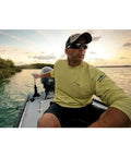 Man on a fishing boat using a Rock Solid Transom Mount Electric Trolling Motor With Telescoping Tiller and Digital Maximizer.