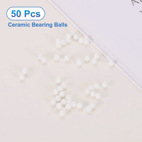 Top Shelf 50 Pack Heavy Duty G10 Precision Zirconia Ceramic Bearing Balls 0.8mm 1 32 Inch scattered on surface.