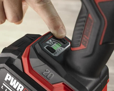 User adjusting speed settings on Tough As Nails Brushless Impact Wrench delivering eight hundred foot pounds of mid torque.