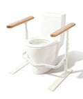 Heavy Duty Toilet Safety Rails For Seniors With Nighttime Reflective Armrests And Base No Fuss Height Adjustments Bulletproof Bathroom Support Bar Fits Standard Toilets Wood Trim next to a standard toilet.