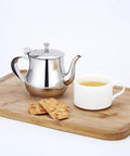 Mini 360Ml Stainless Steel Teapot For Tea And More on wooden tray with cup and biscuits