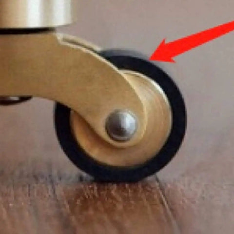 Solid Brass Swivel Castor Wheels With Smooth Rubber Glides For Heavy Furniture Vintage Antique Dining Chair Casters close-up of wheel on wood floor
