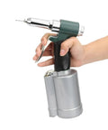 Top Shelf Three Piece Pneumatic Rivet Gun Kit With Heavy Duty Hydraulic Piston And Snappy Quick Release Action held in hand for easy operation.