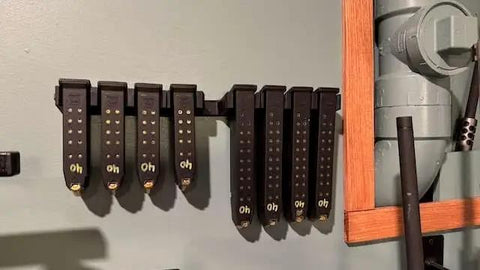 Lock Down Your Gear With This Heavy Duty Magazine Rack Precision Fit For Glock 17 19 26 31 32 33 34 Mags mounted on wall with magazines organized.