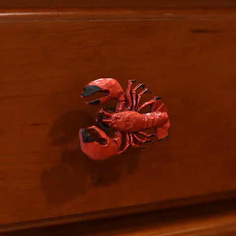 Close-up of Premium Red Lobster Metal Drawer Pulls Featuring A Slick Distressed Finish For Nautical Cabinet Hardware.