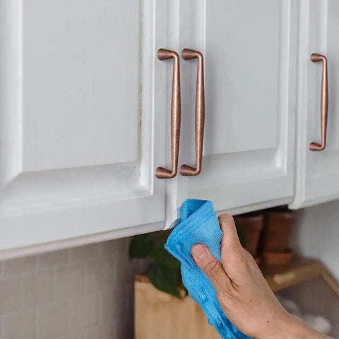 Person cleaning white cabinets with vintage antique copper cabinet handles from Kick The Cozy Factor Up With These Vintage Antique Copper Cabinet Handles Silky Smooth Zinc Alloy Drawer Pulls Tough As Nails 96Mm Hole Center Kitchen And Bedroom Furniture Hardware Six Pack Done Deal.